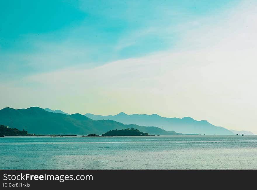 Landscape Photo of Mountain over Body of Water