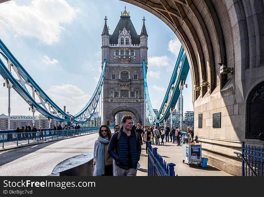 Man and Woman Standing Near Brown Concrete Building