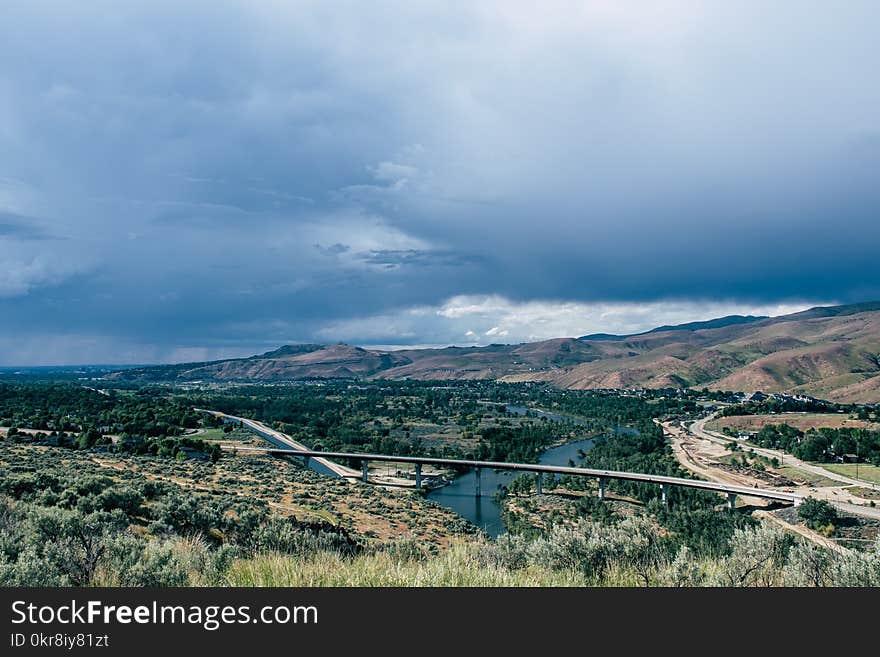 Landscape Photo of Gray Concrete Bridge Under Body of Water