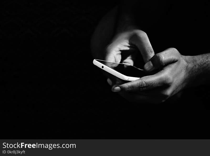 Grey Scale Photo of Person Holding Smartphone