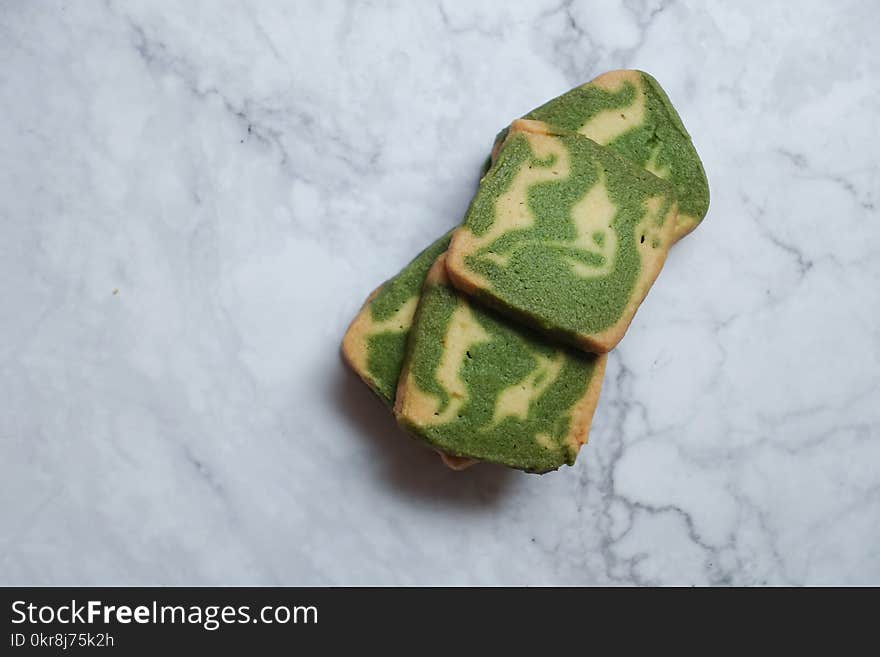 Green and Brown Pastries on White Surface