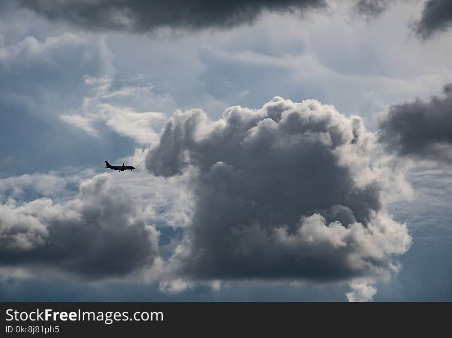 Airplane Flying Near Gray Clouds