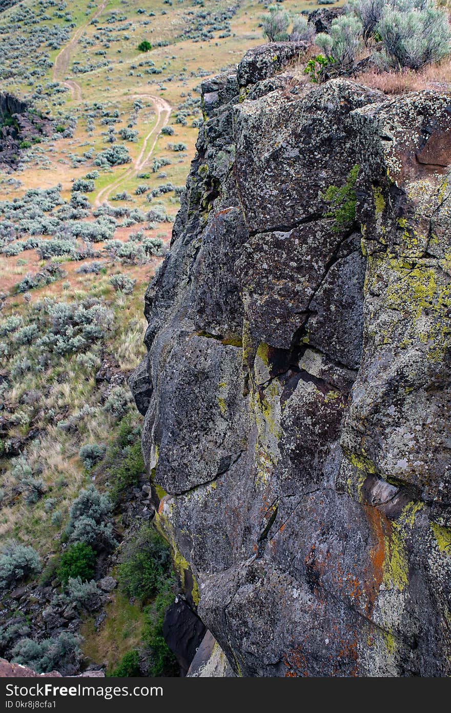 Gray Rock Formation With Grass