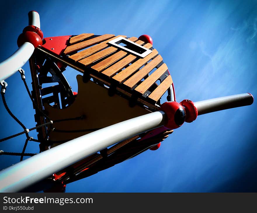 Abstract treehouse in playground with blue sky above