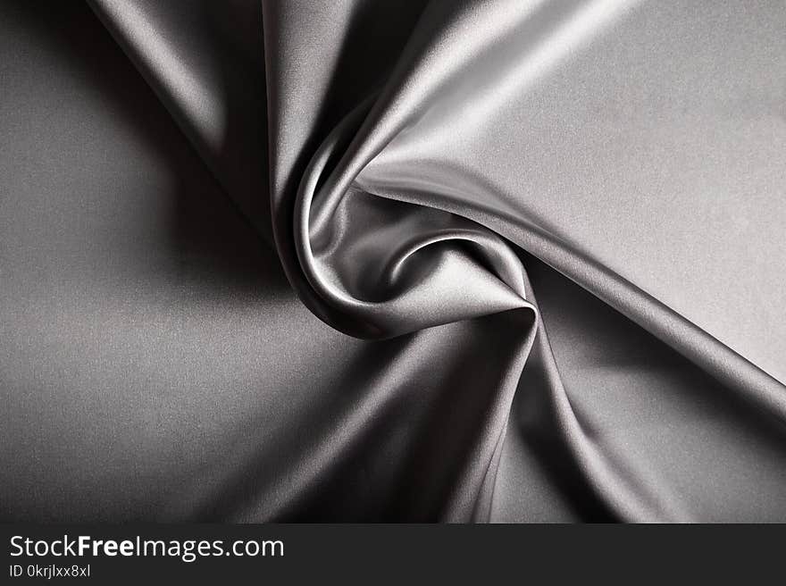 Shiny silver satin curved in various lines.