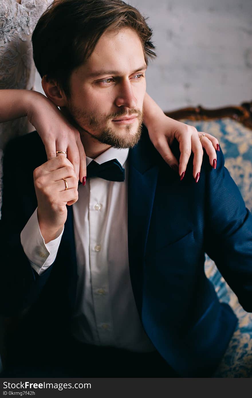 Hands of the bride lie on the shoulders of the groom. Hands of the bride lie on the shoulders of the groom