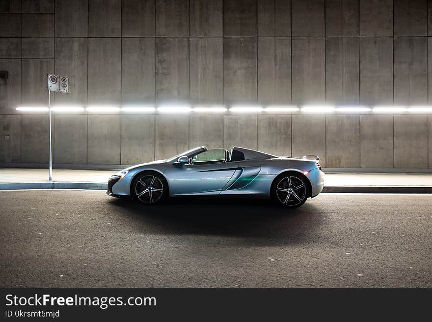 Silver Mclaren 650s Convertible Coupe on Gray Concrete Road