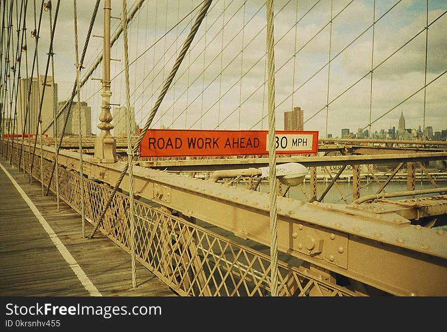 Red and White Signage With Road Work Ahead Text