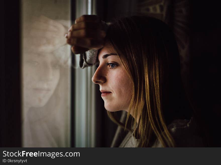 Woman Leaning on Glass Window