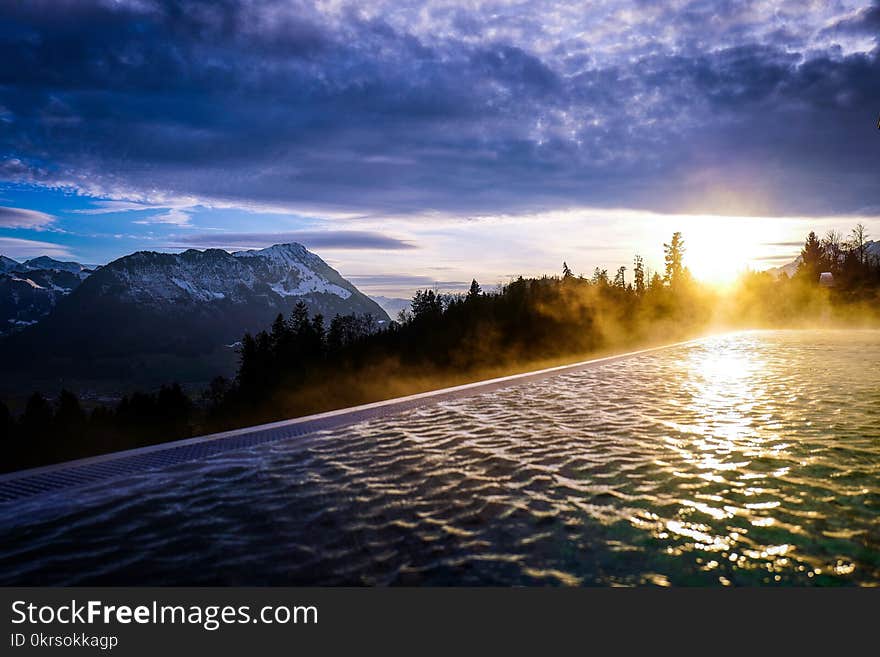 Infinity Pool Near the Forest during Golden Hour