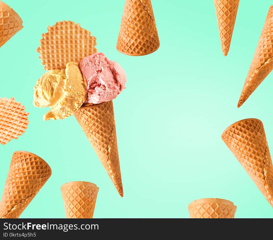 Mixed ice cream and waffle cone on fresh green background