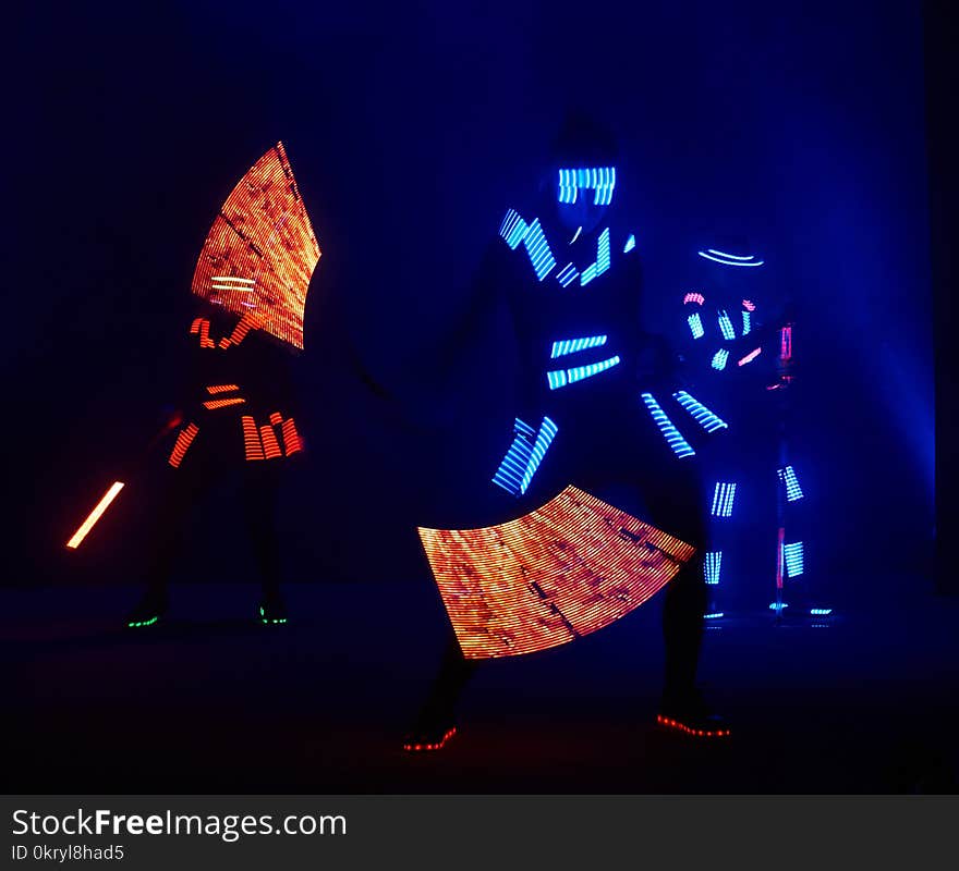 Laser show performance, dancers in led suits with LED lamp, very beautiful night club performance, party