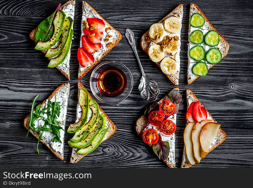 Triangle sandwiches set on dark wooden table background top view. Triangle sandwiches set on dark wooden table background top view