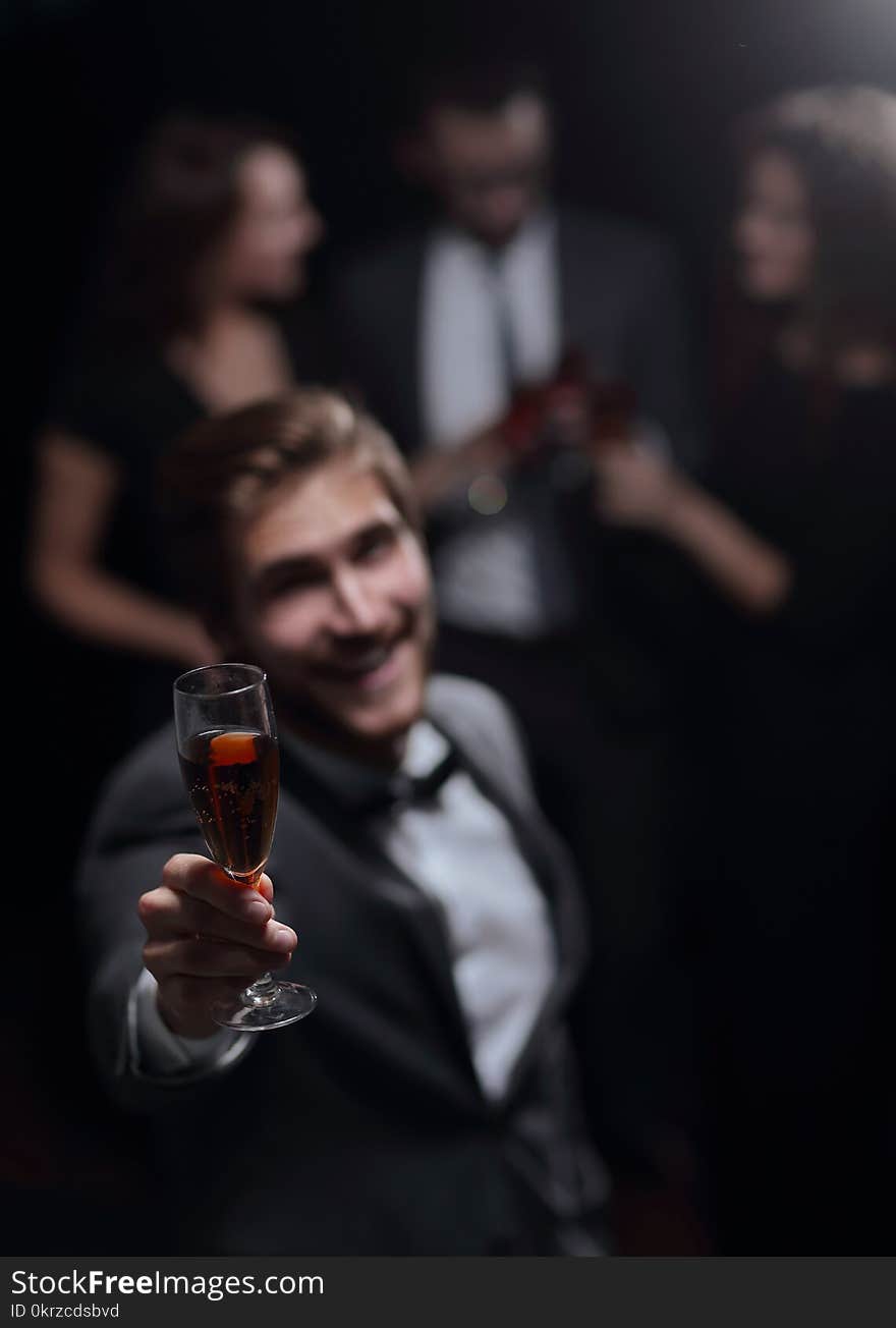 Stylish young men raising his glass in a toast.the holidays and events. Stylish young men raising his glass in a toast.the holidays and events.