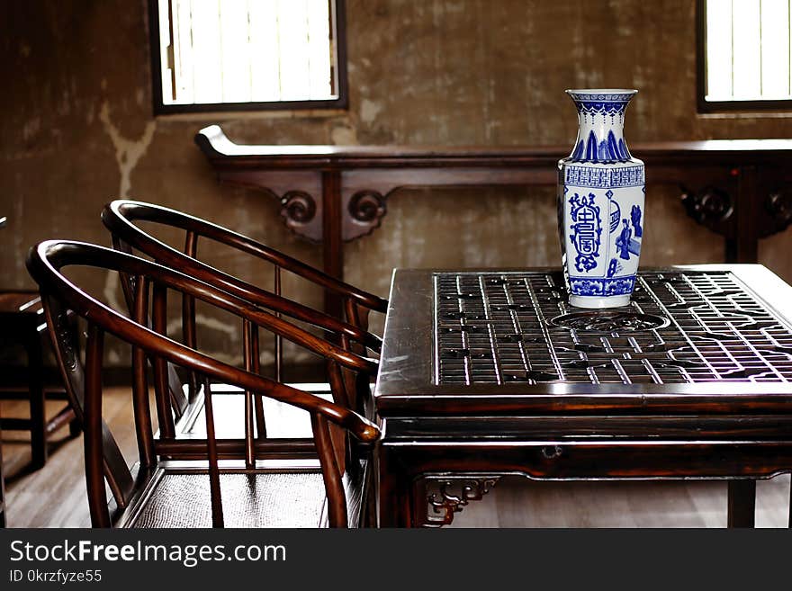 Chinaware is on a wooden table in a Chinese style room. Chinaware is on a wooden table in a Chinese style room.