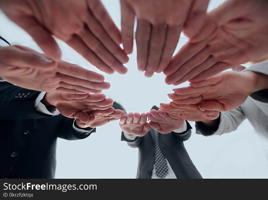 Concept of teamwork and unity. business team folding of the hands in a circle