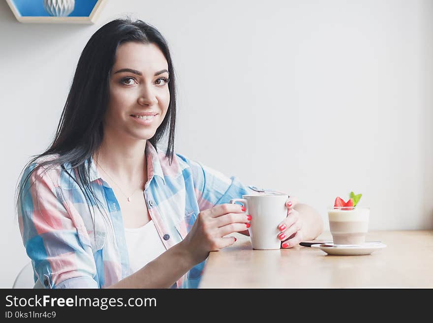 Woman In The Cafe With A Cup Of Coffee And Strawberry Dessert