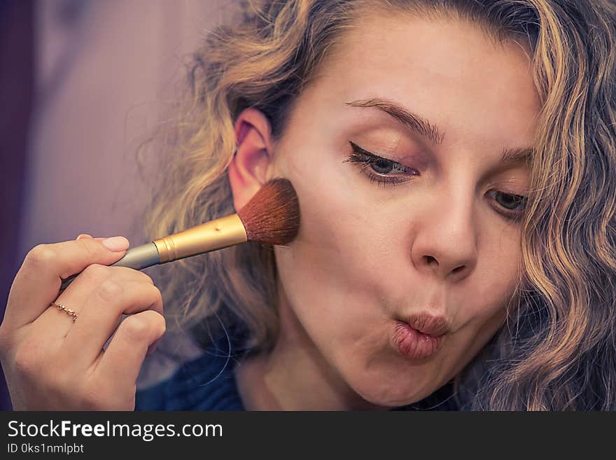 Girl doing makeup on her face