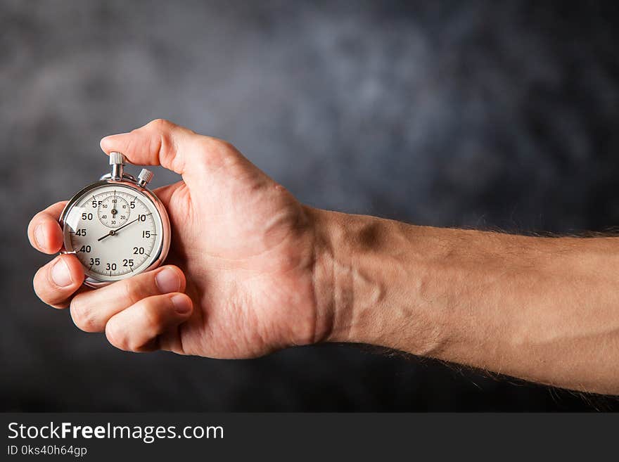 Analog stopwatch on black background