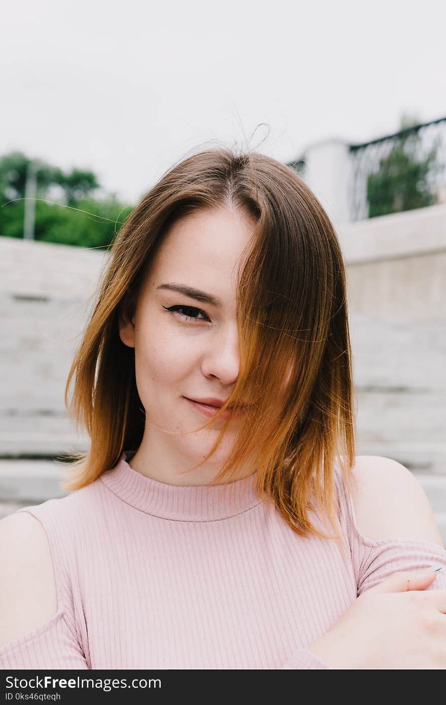 Portrait of a stylish woman on a concrete wall background.