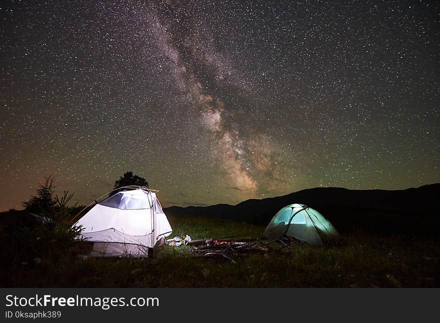 Two Illuminated Tents At Night Under Starry Sky With Milky Way