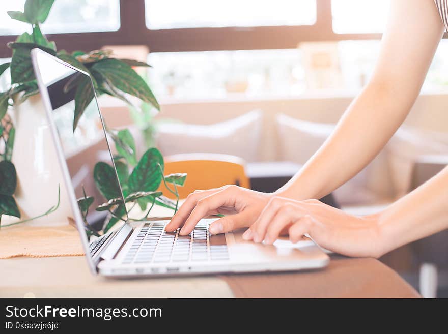 Woman hand works on a laptop computer in the office.