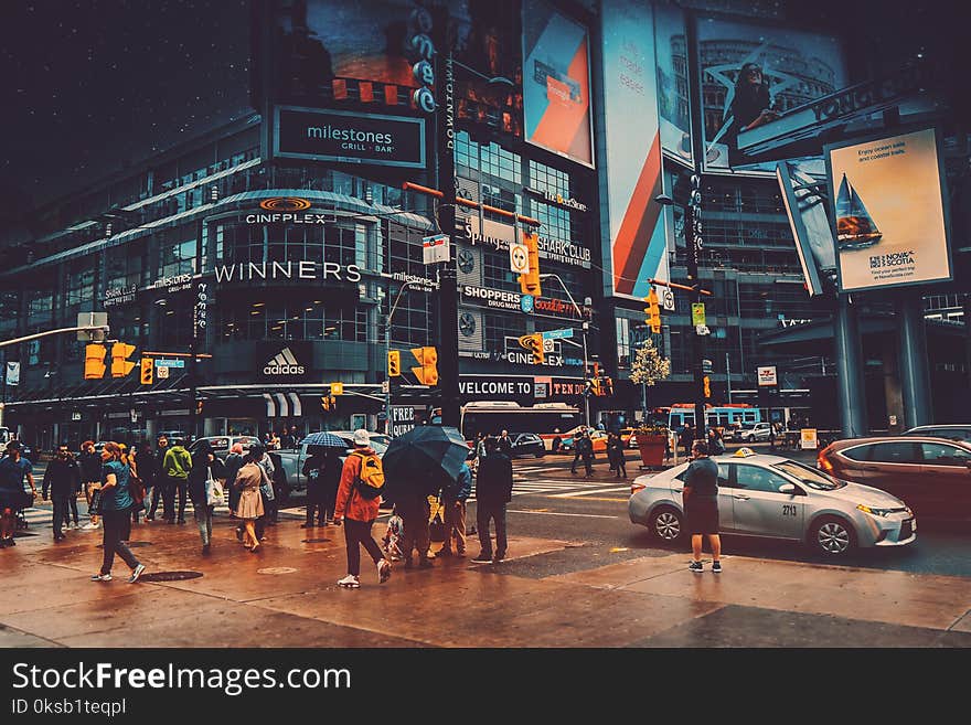 People Walking Near Crossroad Beside Building