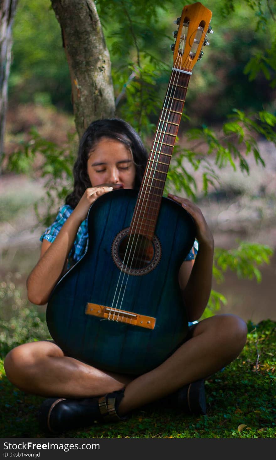 Woman Holding Blue Classical Guitar