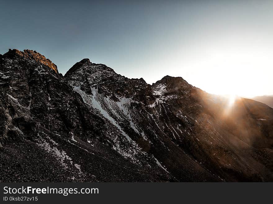 Gray Rock Mountain With White Snow during Sun Rise Aerial Photography