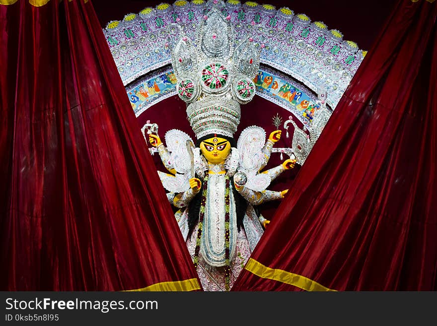 Red curtains getting revealing durga idol for worship