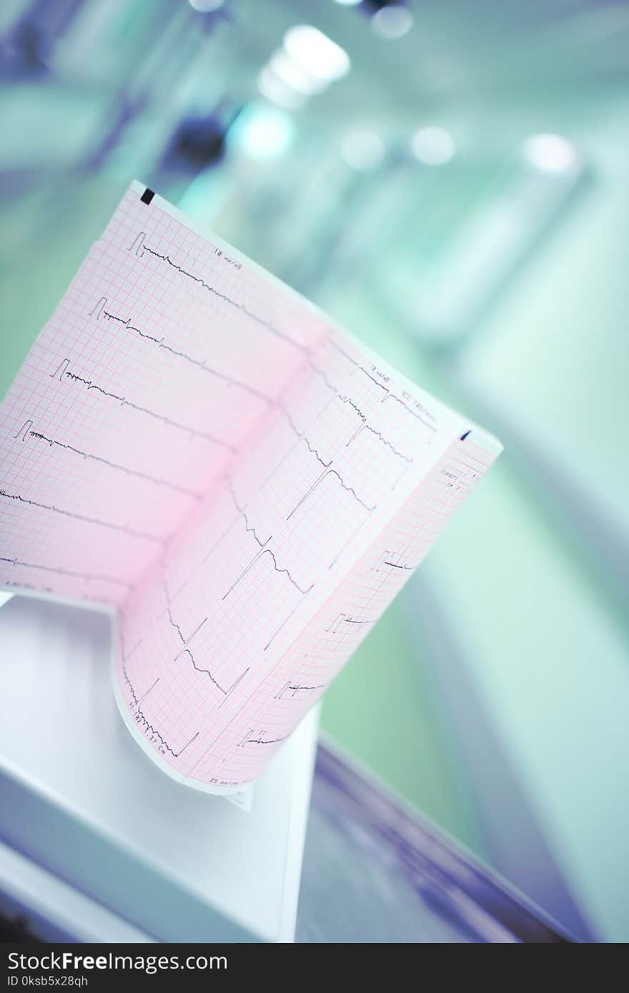 Heart examination test result on the background of blurred hospital corridor.