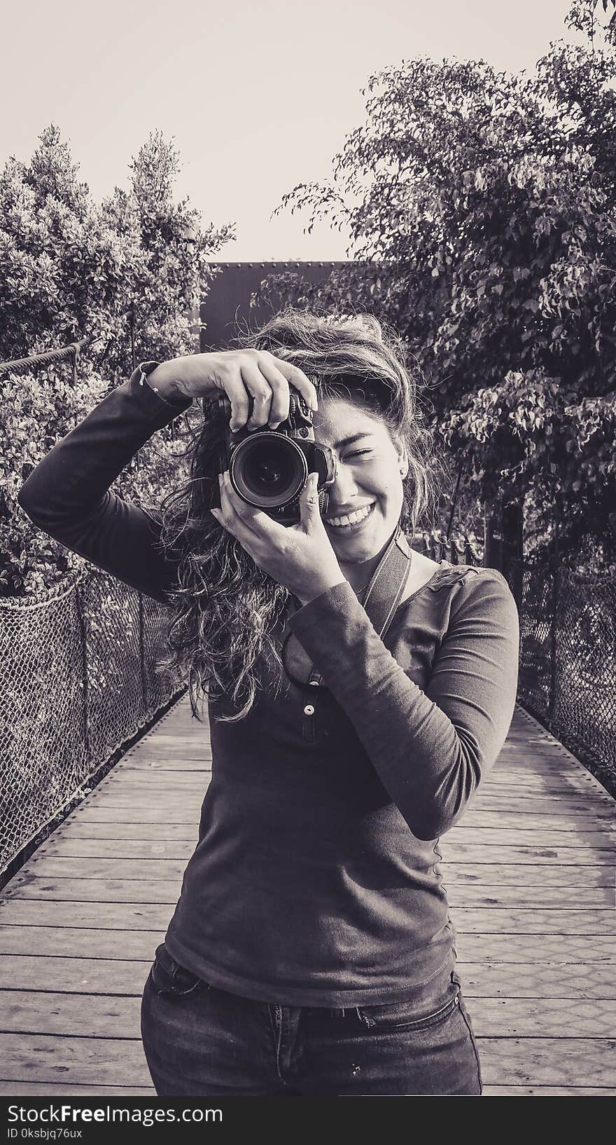 Outdoor summer smiling lifestyle portrait of pretty young woman having fun in the city of Lima taking pictures