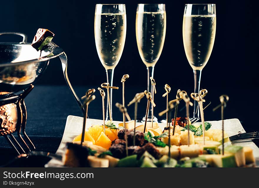 Chocolate fondue with fruits on black table