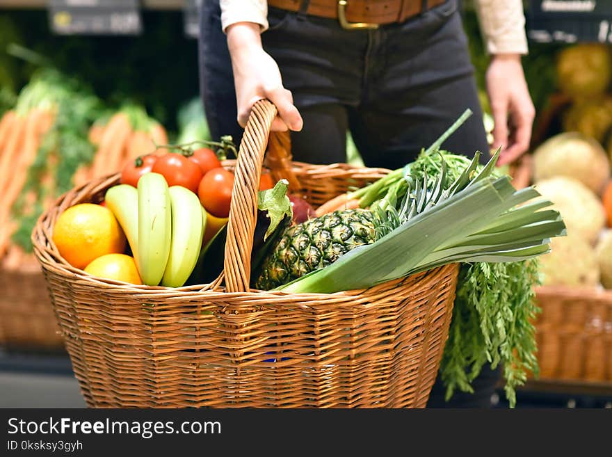 Grocery shopping in the supermarket - filled shopping trolley with fresh fruit and vegetables