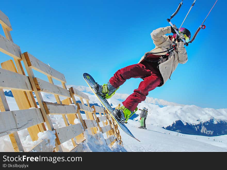 snowkiter in Sinaia Romania performing snowkiting tricks outdoor - Snowboarding evolution, new sport for snowboarders. snowkiter in Sinaia Romania performing snowkiting tricks outdoor - Snowboarding evolution, new sport for snowboarders