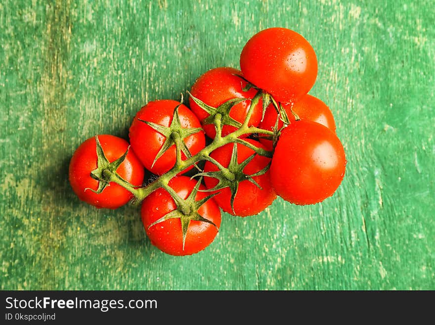 Fresh ripe tomatoes on wooden background, top view