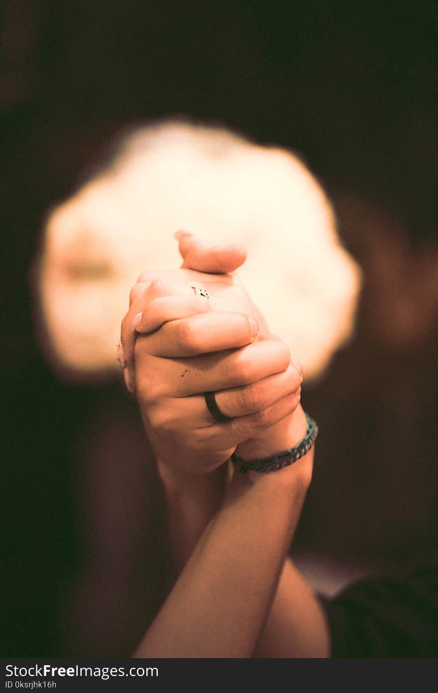 Shallow Focus Photography of Two Persons Holding Hands