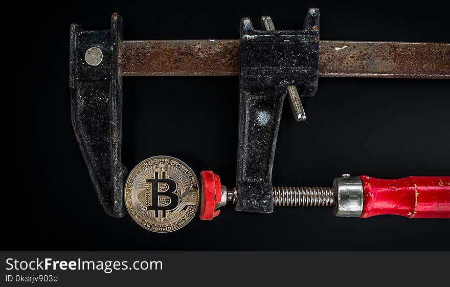 Black and Red Caliper on Gold-colored Bitcoin