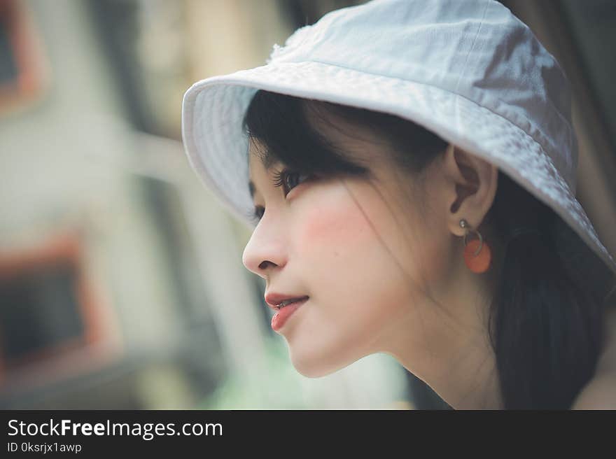 Selective Focus Photo of Woman Wearing White Cap