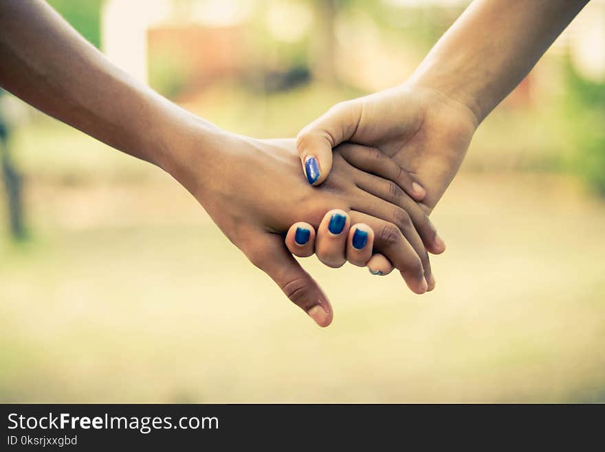 Two People Holding Hands