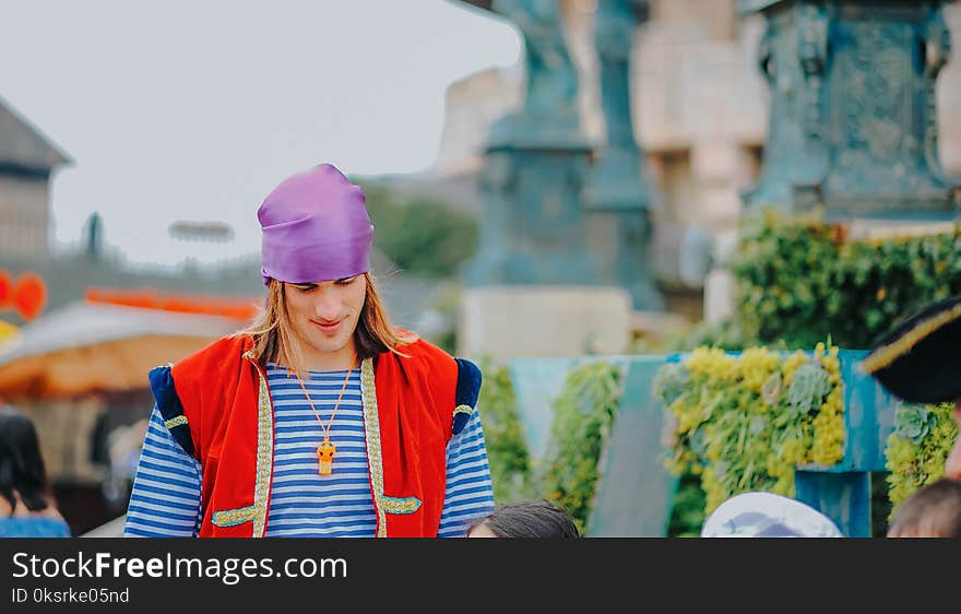 Man Wearing Red Vest And Blue Striped Shirt