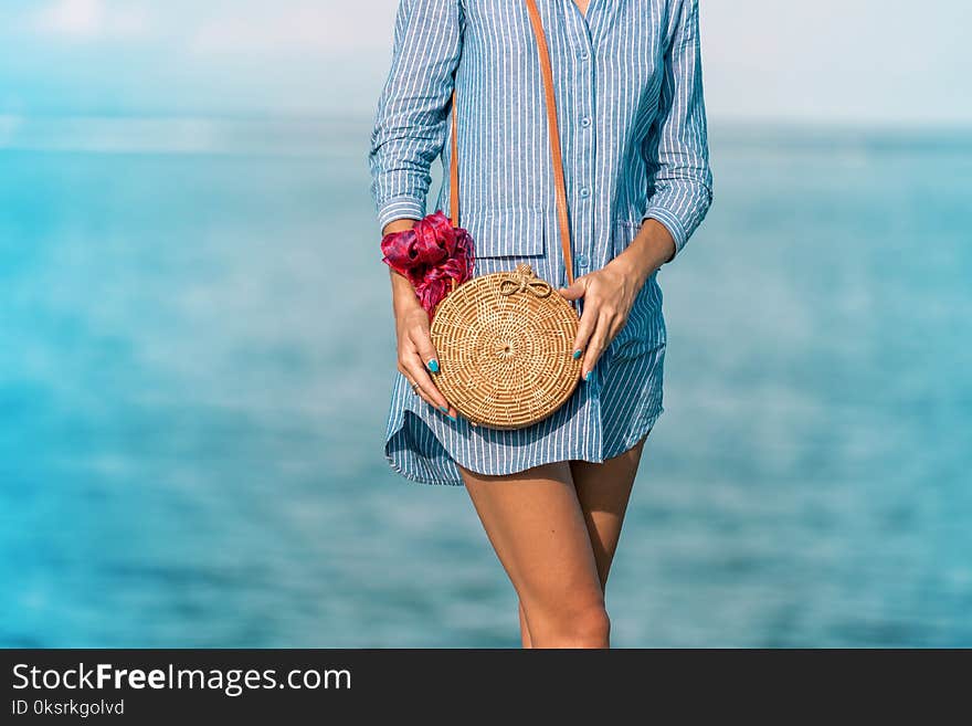 Woman Wearing Blue Long-sleeved Button-up Dress And Brown Sling Bag