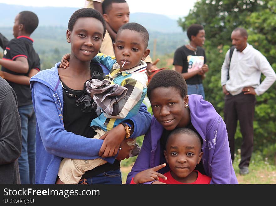 Woman Wearing Blue Jacket Carrying A Little boy