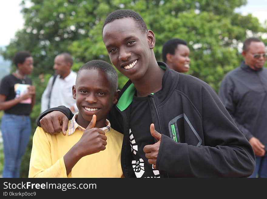 Two Boys Doing Thumbs Up Sign