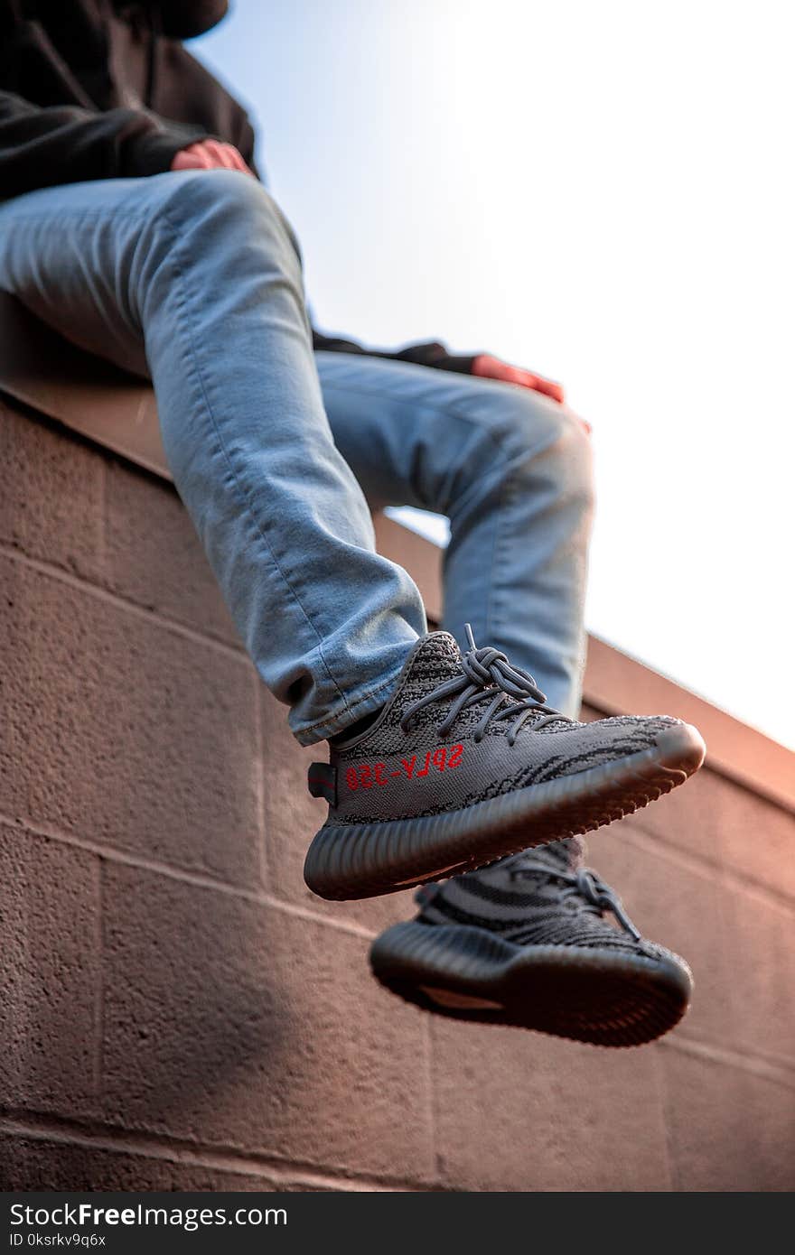 Person Wearing Adidas Yeezy Boost Shoes