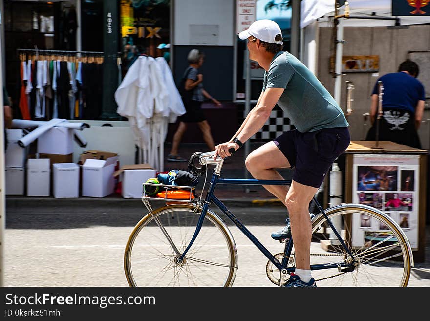 Man Wearing Grey T-shirt Riding Bicycle