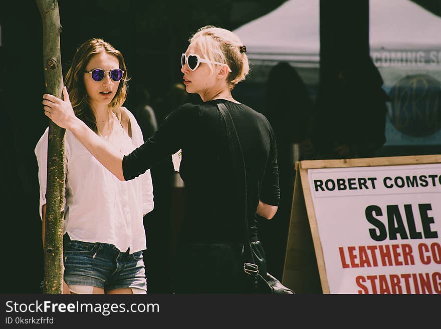 Two Women Wearing Sunglasses