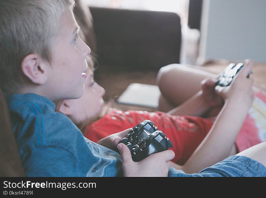 Two Boy and Girl Holding Game Controllers