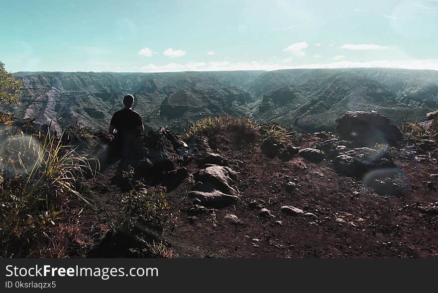 Person Standing Near Cliff