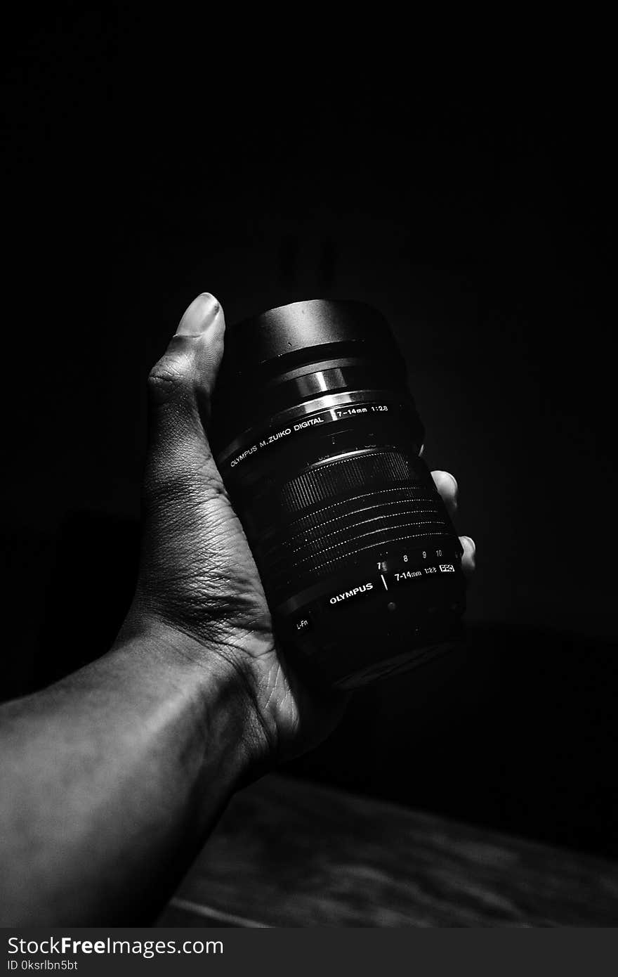 Person Holding Olympus Camera Lens